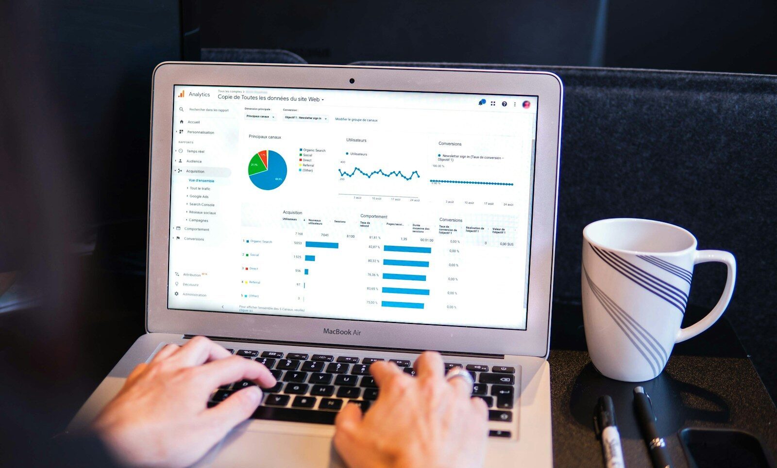 person using macbook pro on black table